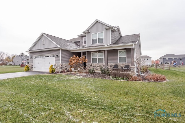 craftsman-style house featuring a garage and a front lawn