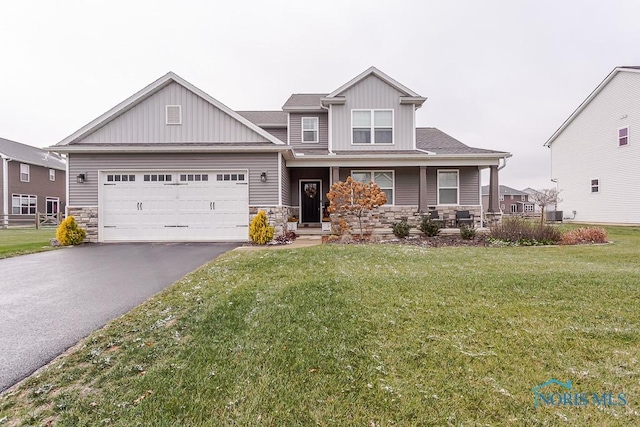 craftsman house featuring a front yard and a garage