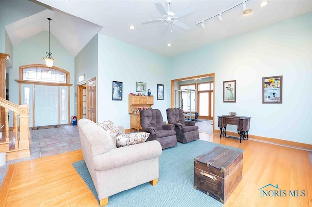 living room featuring ceiling fan, high vaulted ceiling, and french doors