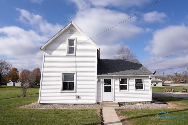 back of house with a yard