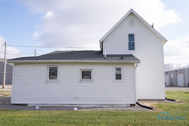 back of property featuring a yard