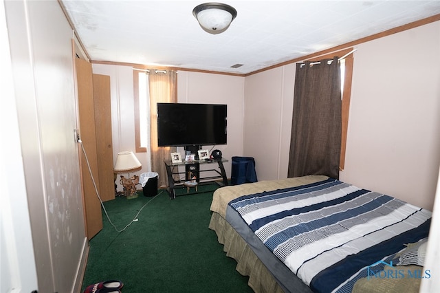 carpeted bedroom with ornamental molding