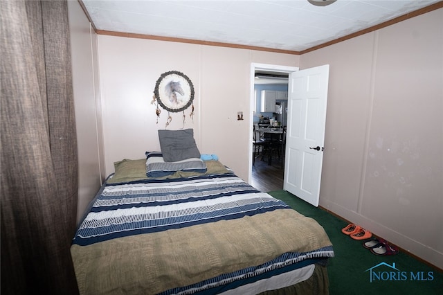 bedroom with dark carpet and crown molding