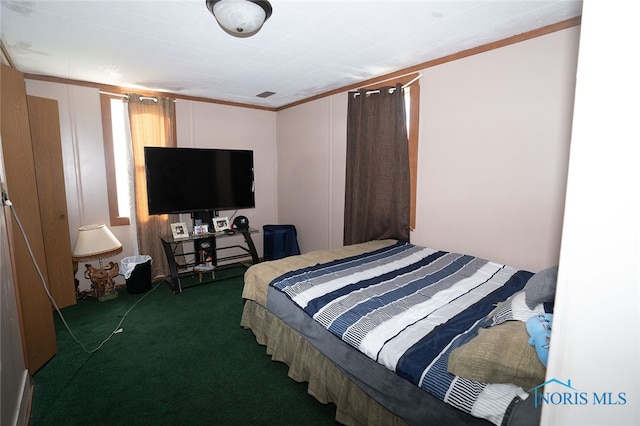 bedroom featuring dark carpet and ornamental molding