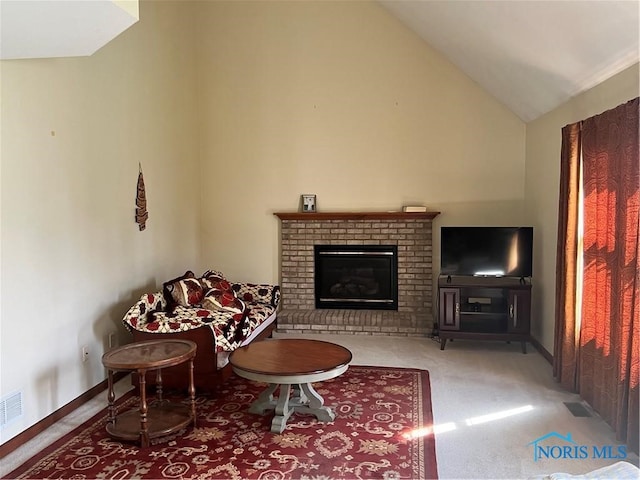 living room featuring carpet flooring, vaulted ceiling, and a brick fireplace