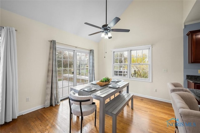 dining area featuring ceiling fan, light hardwood / wood-style flooring, and lofted ceiling