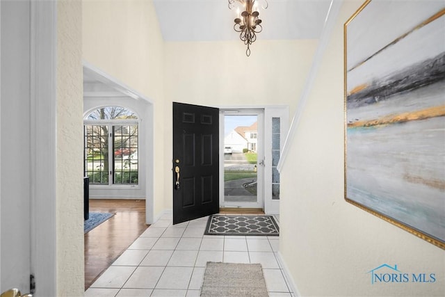 entryway featuring a high ceiling and light hardwood / wood-style floors