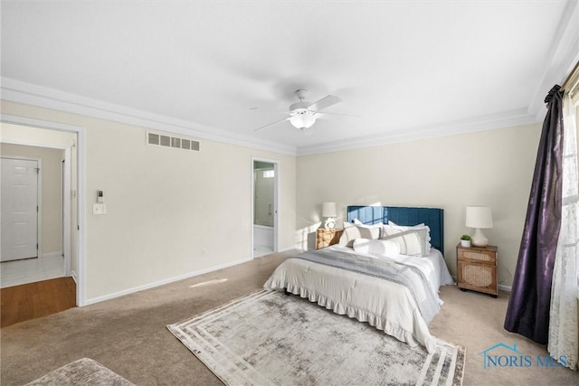 bedroom featuring ceiling fan, light colored carpet, ensuite bathroom, and crown molding