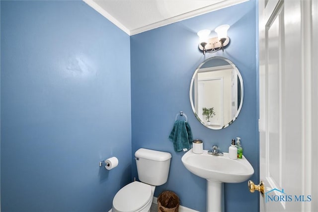 bathroom with crown molding and toilet