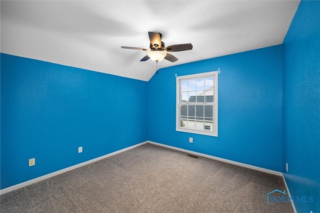 unfurnished room featuring ceiling fan, carpet floors, and vaulted ceiling