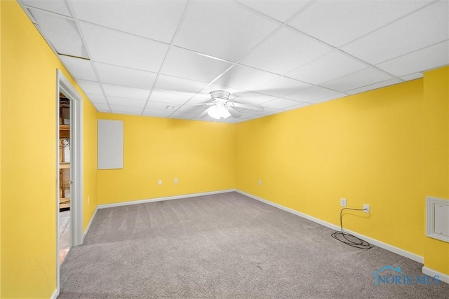 carpeted empty room featuring a paneled ceiling and ceiling fan