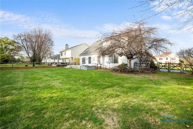 rear view of house featuring a yard