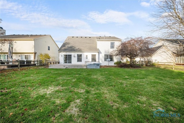 rear view of house with a yard