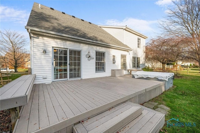 wooden terrace featuring a lawn and a covered pool