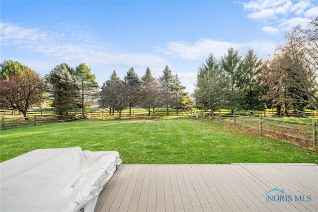 view of yard with a rural view and a deck