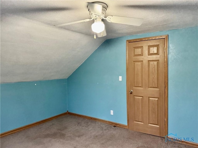 bonus room featuring carpet flooring, ceiling fan, a textured ceiling, and vaulted ceiling