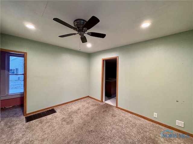 unfurnished bedroom with carpet floors, a spacious closet, a closet, and ceiling fan