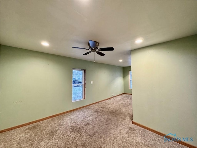 spare room with carpet flooring and ceiling fan