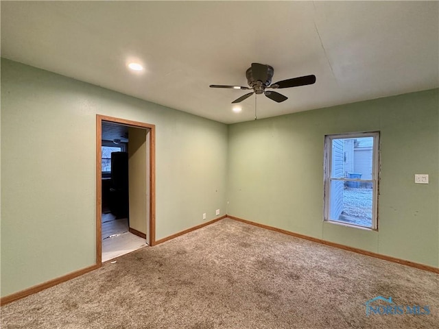 spare room with light carpet and ceiling fan