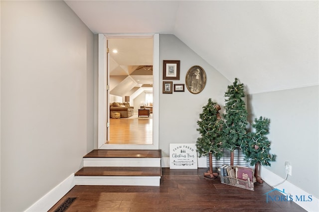 corridor featuring vaulted ceiling and dark hardwood / wood-style floors