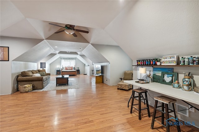 interior space featuring ceiling fan, light hardwood / wood-style floors, and vaulted ceiling