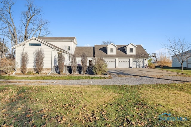 cape cod house with a garage and a front lawn