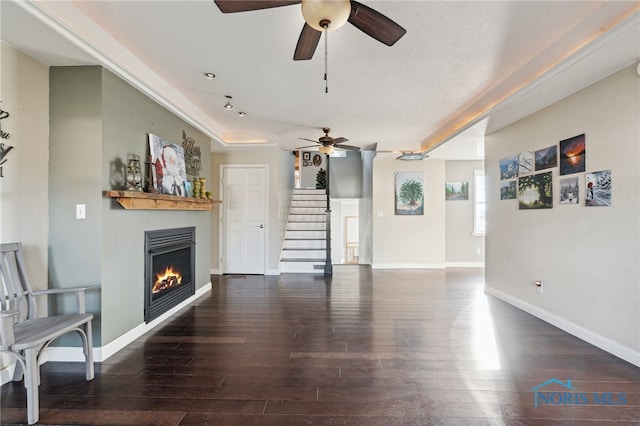 living room with dark hardwood / wood-style floors and ceiling fan