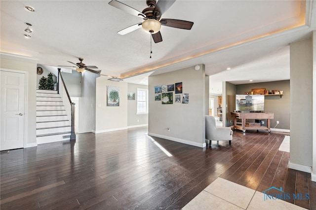 living room featuring ceiling fan and dark hardwood / wood-style flooring