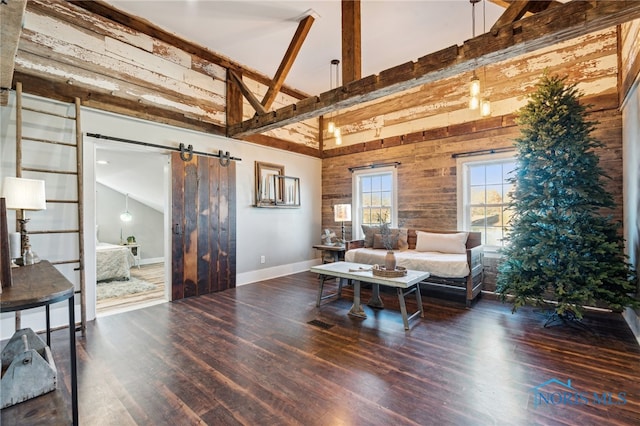 living room featuring beam ceiling, a barn door, dark hardwood / wood-style flooring, and high vaulted ceiling