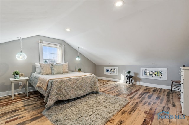 bedroom with dark hardwood / wood-style flooring and vaulted ceiling