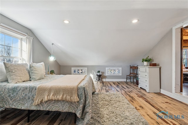 bedroom featuring hardwood / wood-style floors and lofted ceiling