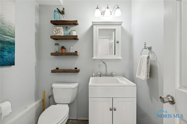 bathroom featuring vanity and toilet