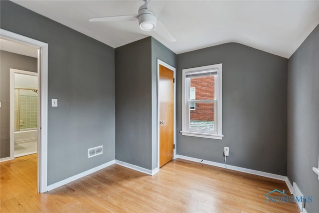 unfurnished bedroom with ceiling fan, light hardwood / wood-style floors, and vaulted ceiling