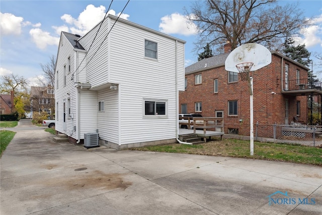 rear view of property featuring a deck and central air condition unit