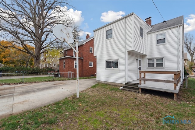 back of house featuring a yard and a deck