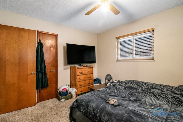 carpeted bedroom with a textured ceiling and ceiling fan