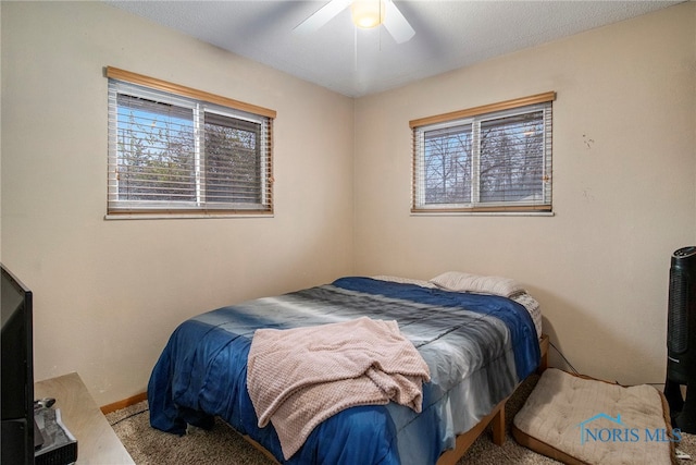 carpeted bedroom featuring ceiling fan