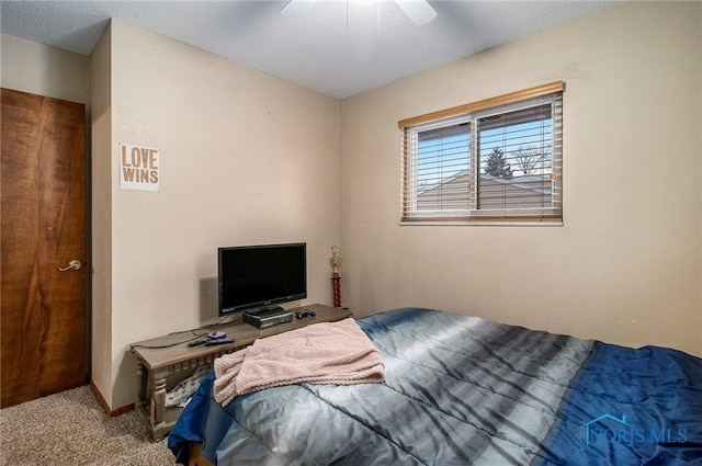 bedroom featuring a textured ceiling, carpet floors, and ceiling fan