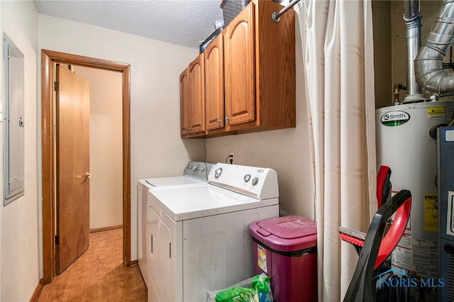 laundry area featuring cabinets, a textured ceiling, water heater, and washing machine and clothes dryer