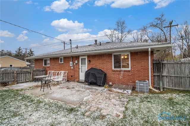 back of property with a patio area and central AC