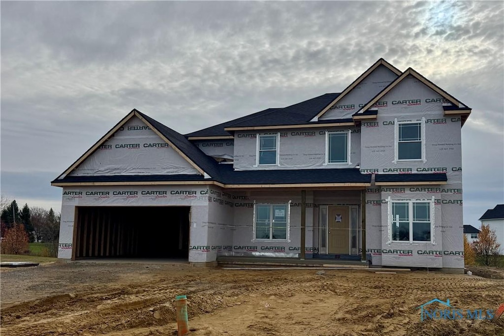 unfinished property featuring a garage