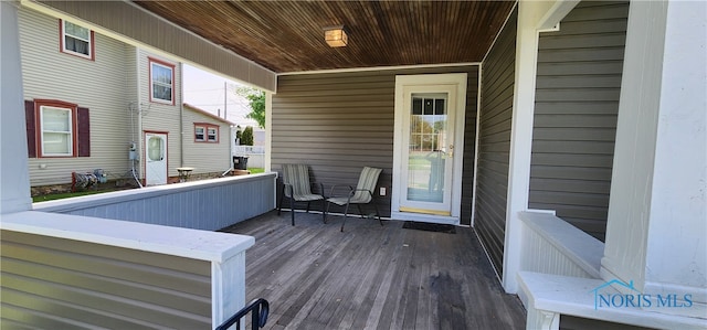 wooden terrace featuring covered porch