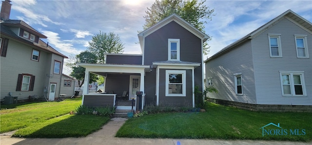 view of front property featuring a porch and a front lawn