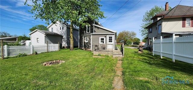 rear view of property featuring a yard