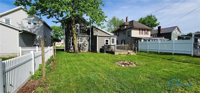 rear view of property with a lawn