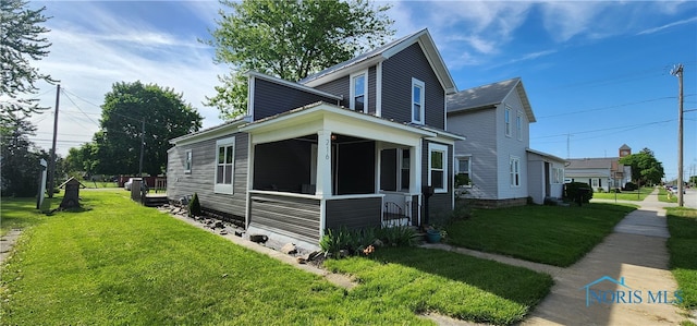 view of property exterior featuring a lawn and a sunroom