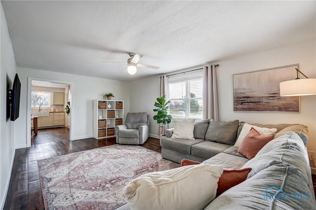 living room featuring ceiling fan and dark hardwood / wood-style flooring