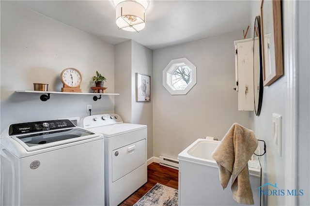 laundry room with sink, baseboard heating, separate washer and dryer, and dark wood-type flooring