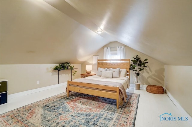 bedroom with lofted ceiling