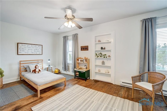 bedroom with hardwood / wood-style flooring, ceiling fan, and baseboard heating